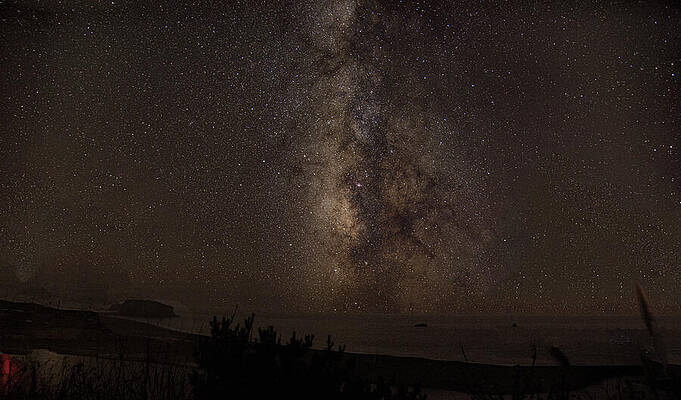 Wall Art featuring the photograph Milky Way Over Tranquil Shoreline by Brandon Wichmann