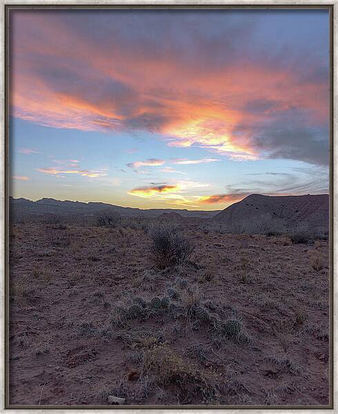 Desert Sunset Over Rugged Terrain Framed Print