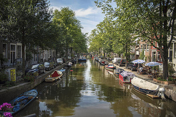 Wall Art featuring the photograph Serene Amsterdam Canal With Boats And Trees by Brandon Wichmann