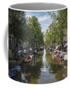 Serene Amsterdam Canal With Boats And Trees Coffee Mug