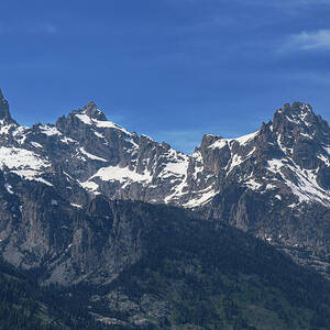 Snow-Capped Teton Mountain Peaks Under Blue Sky by Brandon Wichmann