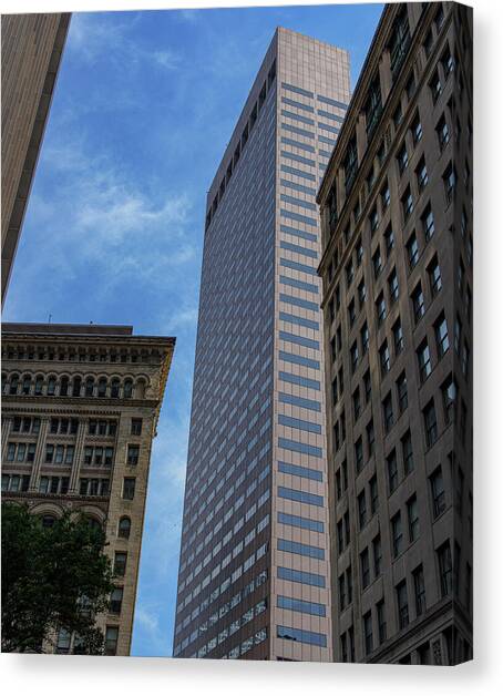 Skyscrapers Against Blue Sky Canvas Art Print by Brandon Wichmann