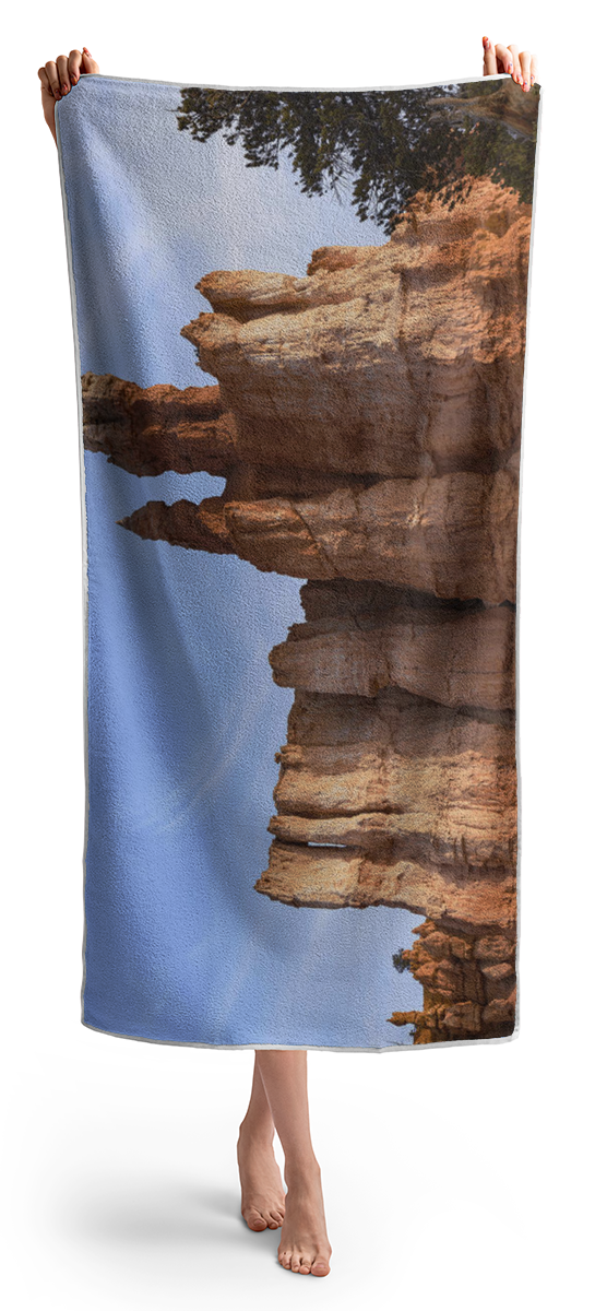 Majestic Rock Formations Under Blue Sky In Bryce Canyon National Park Beach Towel