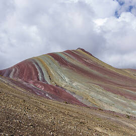 Colorful Rainbow Mountain Under Cloudy Sky by Brandon Wichmann