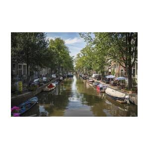 Serene Amsterdam Canal with Boats and Trees by Brandon Wichmann