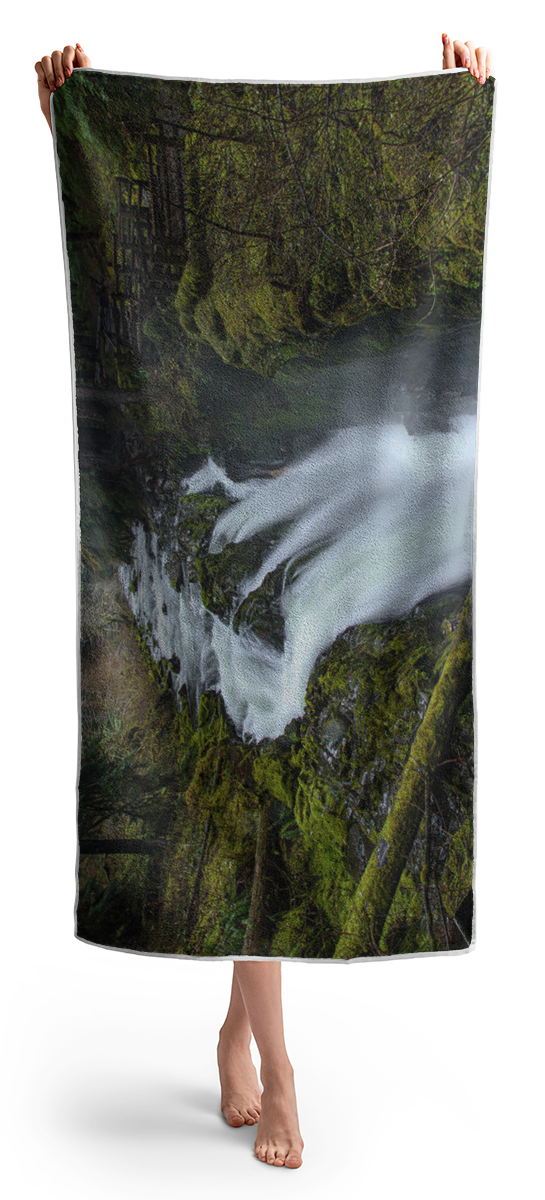 Serene Flow Through Mossy Forest Beach Towel